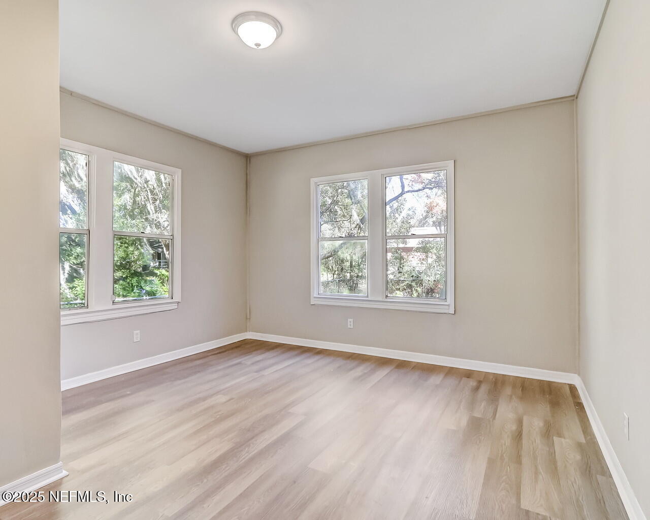 8951 6th Avenue Jacksonville, FL 32208 - Photo 23 of 29 an empty room with wooden floor and windows