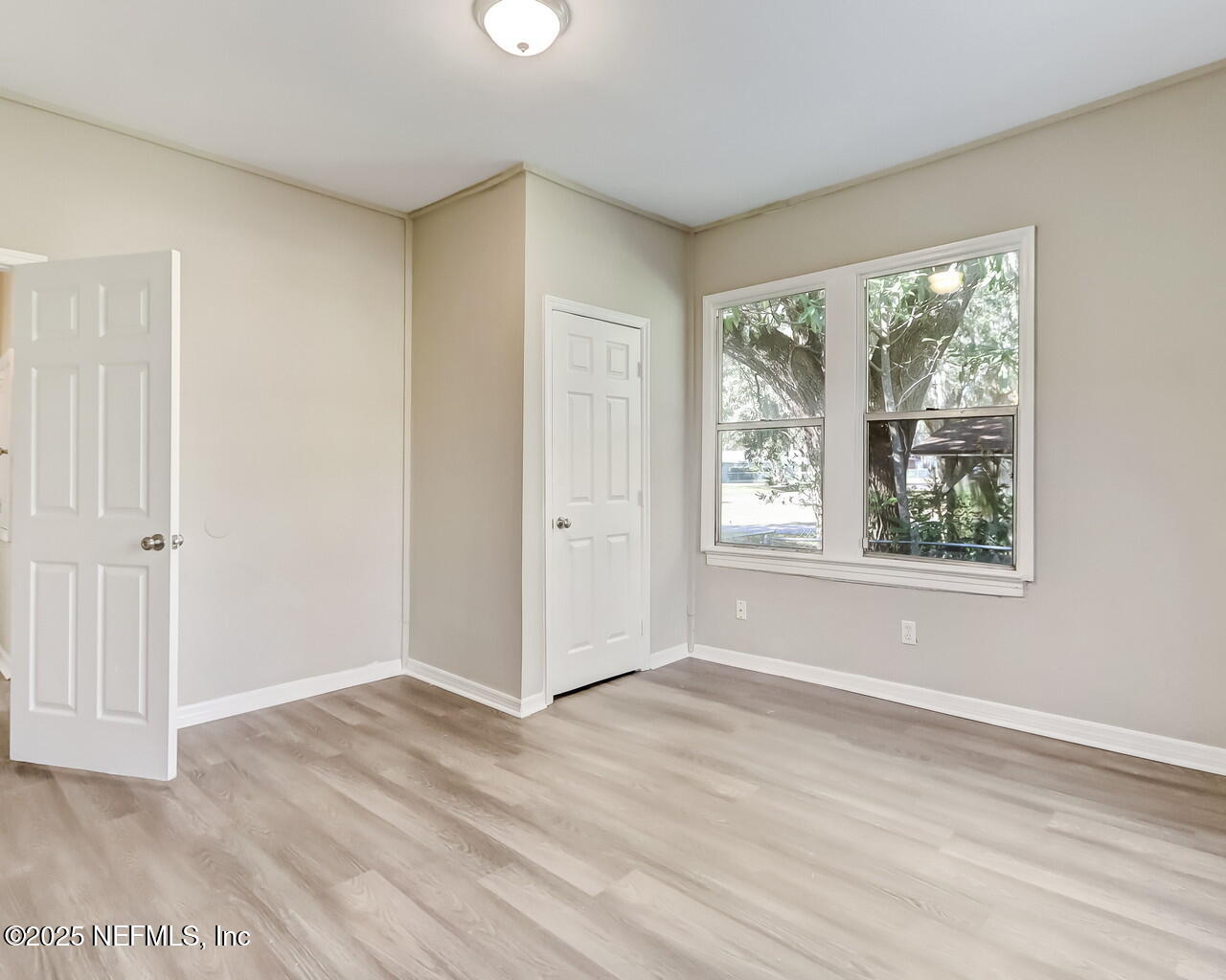 8951 6th Avenue Jacksonville, FL 32208 - Photo 24 of 29 a view of an empty room with wooden floor and a window