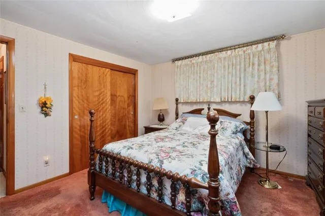 a bed sitting in a bedroom next to a window