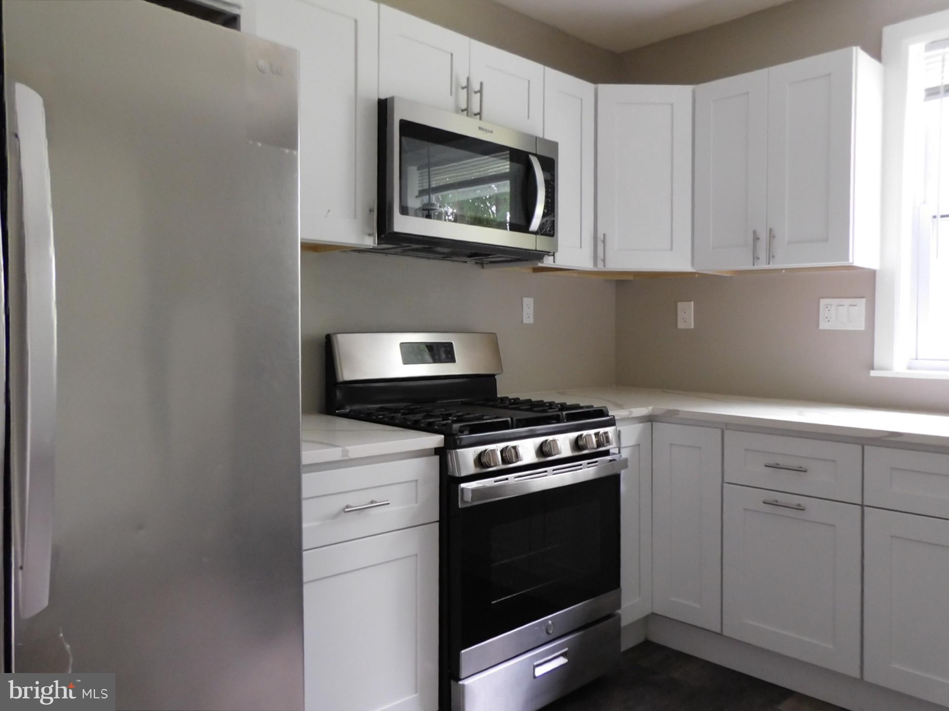623 3rd Street Delanco, NJ 08075 - Photo 8 of 44 a kitchen with stainless steel appliances granite countertop white cabinets a sink a stove and a microwave