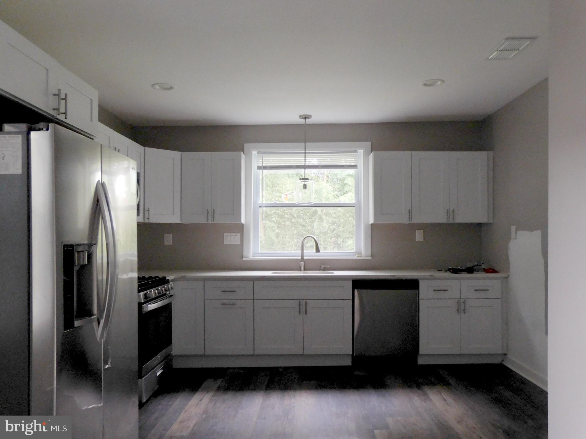 623 3rd Street Delanco, NJ 08075 - Photo 9 of 44 a kitchen with a sink a window and stainless steel appliances