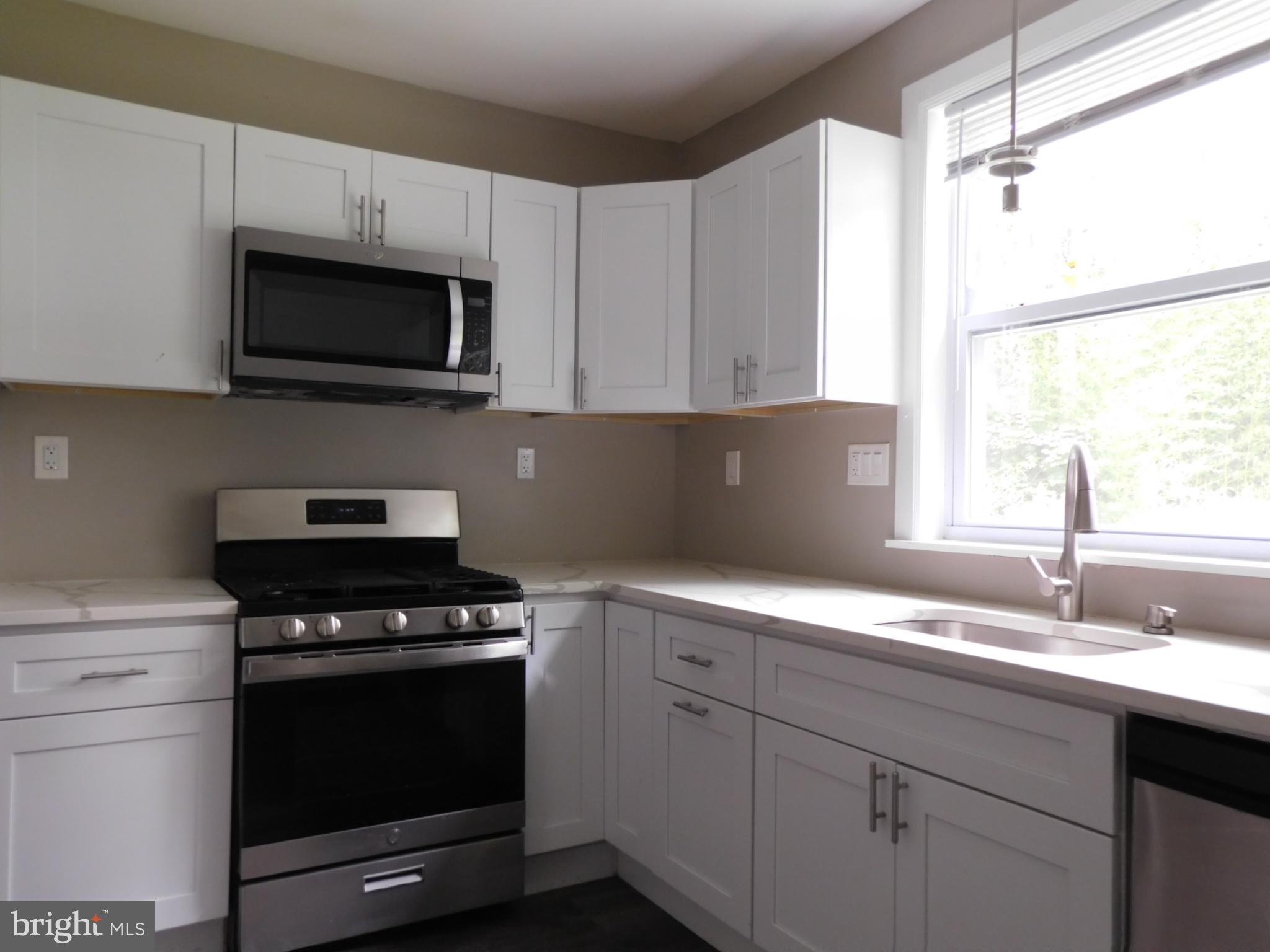 623 3rd Street Delanco, NJ 08075 - Photo 10 of 44 a kitchen with a sink stove and microwave