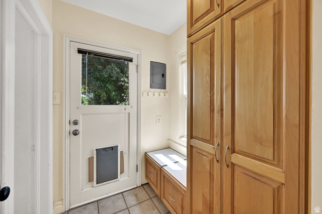 291 800 East Bountiful, UT 84010 - Photo 8 of 20 Entryway featuring extensive built-in cabinetry, tile flooring, a window, and a built-in bench with storage