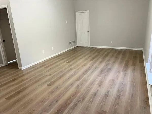 a view of room with wooden floor