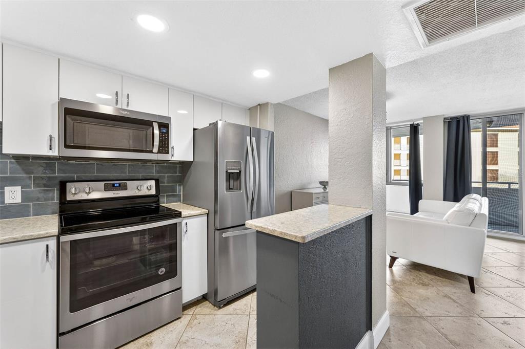 470 3rd Street South, Unit 318 St. Petersburg, FL 33701 - Photo 13 of 45 a kitchen with a sink stove and refrigerator