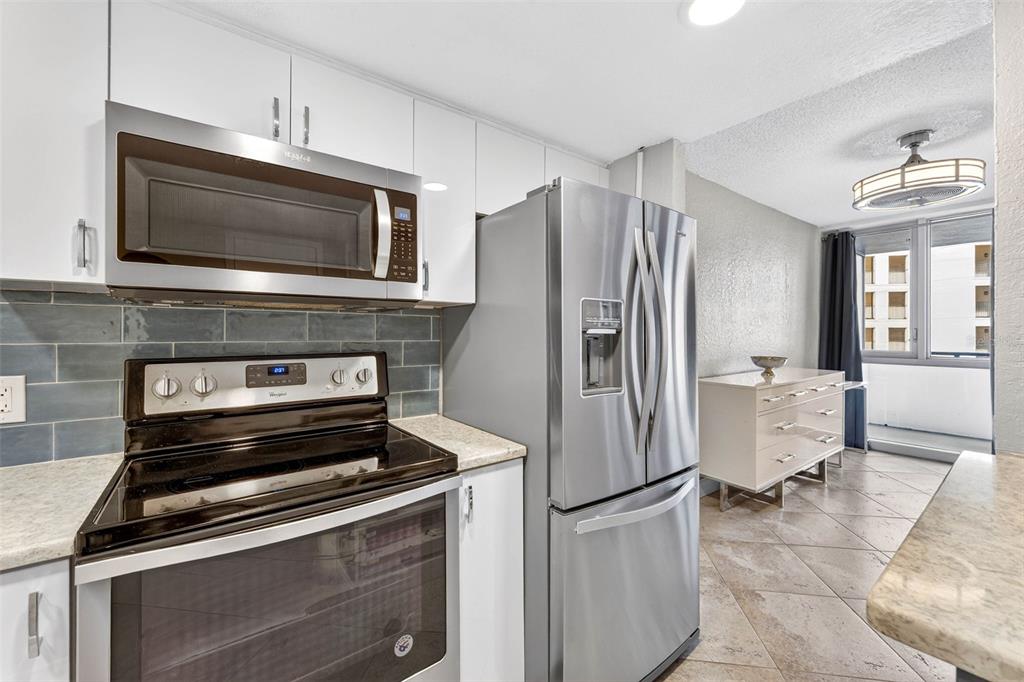 470 3rd Street South, Unit 318 St. Petersburg, FL 33701 - Photo 16 of 45 a kitchen with a stove microwave and refrigerator