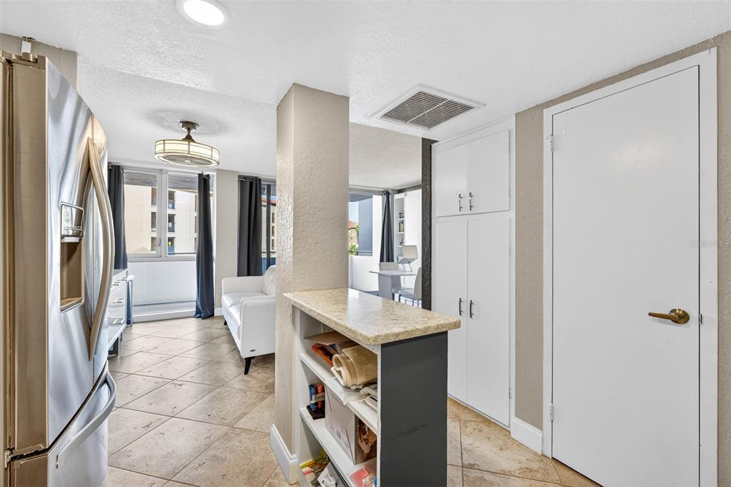 470 3rd Street South, Unit 318 St. Petersburg, FL 33701 - Photo 17 of 45 a room with stainless steel appliances a refrigerator and a view of living room