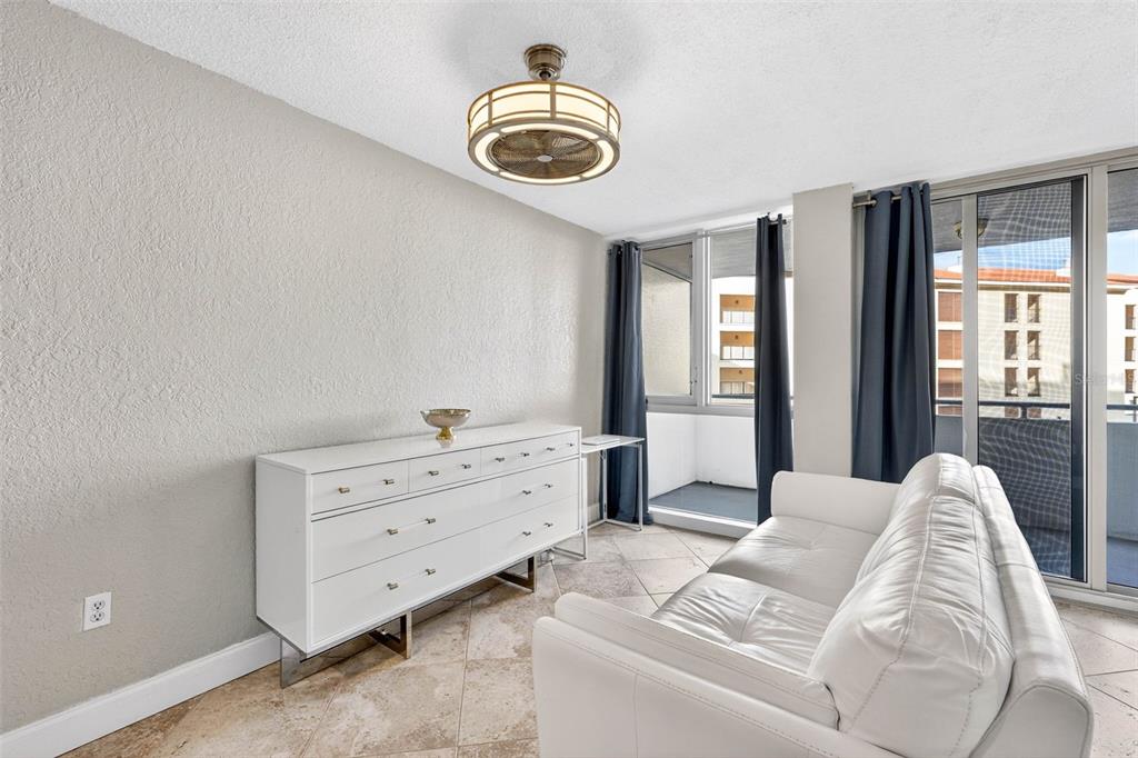 470 3rd Street South, Unit 318 St. Petersburg, FL 33701 - Photo 18 of 45 a bedroom with a bed and a chandelier