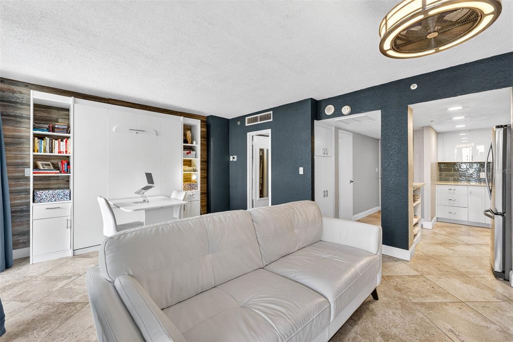 470 3rd Street South, Unit 318 St. Petersburg, FL 33701 - Photo 21 of 45 a living room with furniture and a large mirror