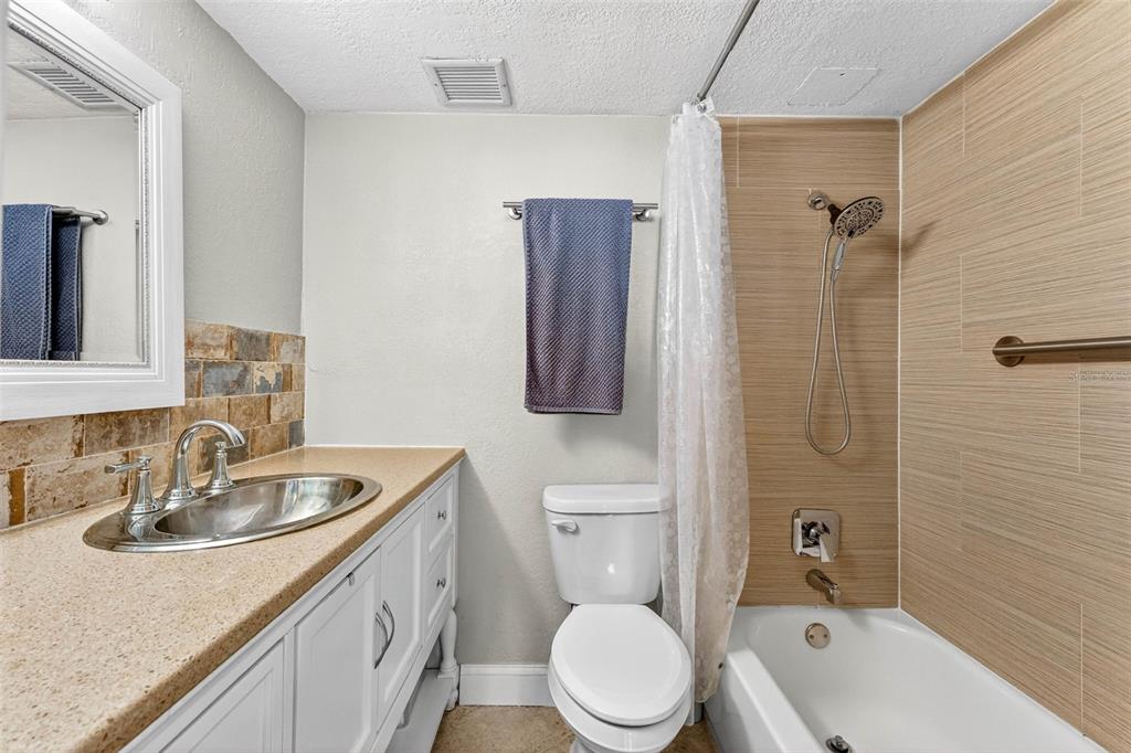 470 3rd Street South, Unit 318 St. Petersburg, FL 33701 - Photo 28 of 45 a bathroom with a sink a toilet and shower
