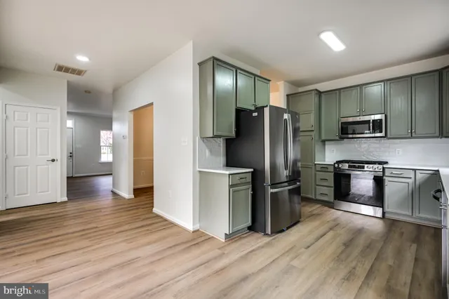 a kitchen with a refrigerator and a sink