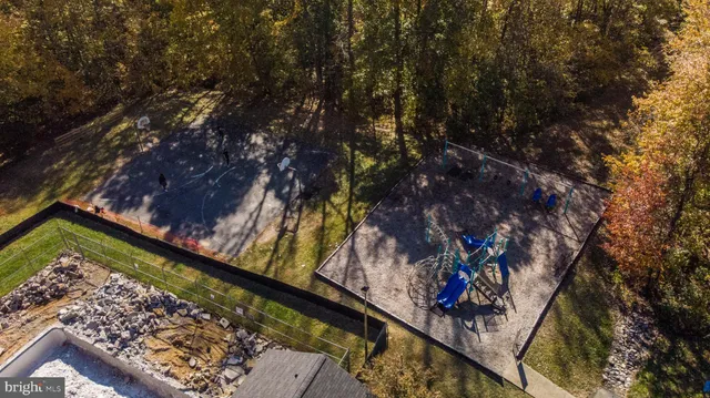 an aerial view of a house with yard and trees
