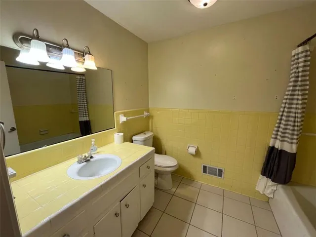 a bathroom with a sink toilet and mirror