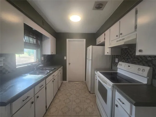 a bathroom with a toilet a sink a vanity and mirror
