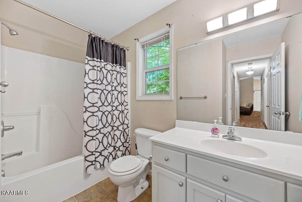 707 Jane Phillips Road Oneida, TN 37841 - Photo 18 of 25 a bathroom with a sink toilet and shower