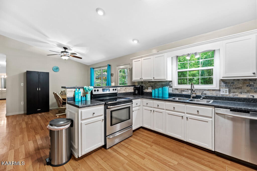 707 Jane Phillips Road Oneida, TN 37841 - Photo 4 of 25 a kitchen with a stove cabinets and wooden floor