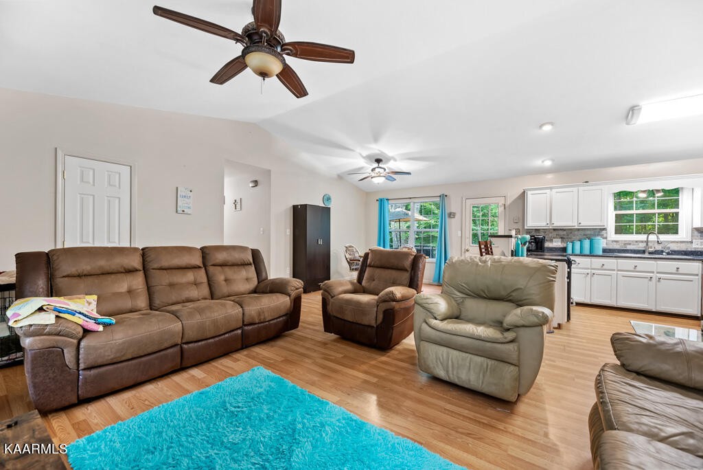707 Jane Phillips Road Oneida, TN 37841 - Photo 7 of 25 a living room with furniture kitchen view and a chandelier