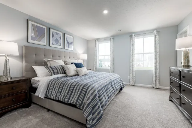 a spacious bedroom with a bed and a cabinets