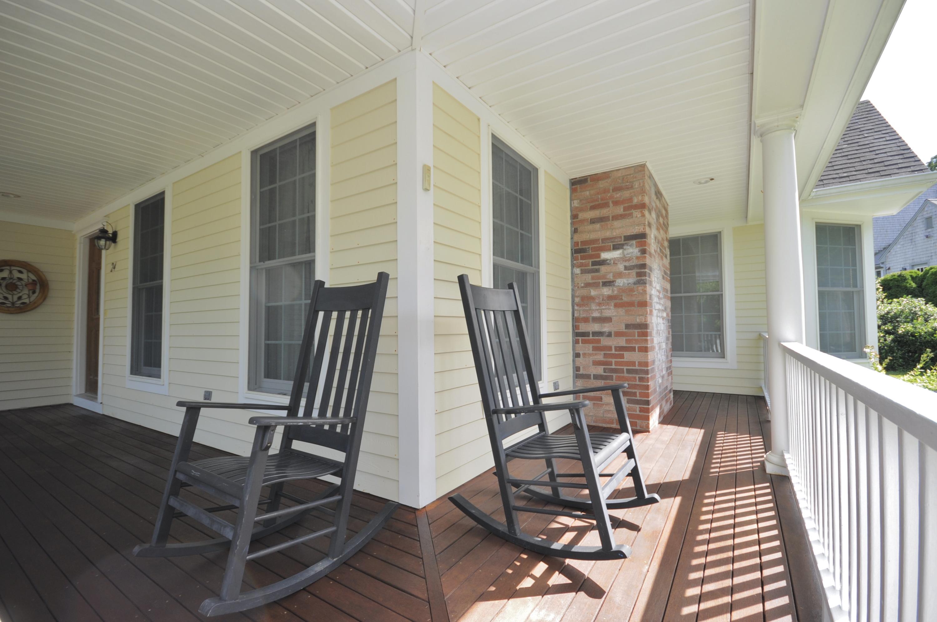 24 Pilgrim Road Sagamore Beach, MA 02562 - Photo 4 of 37 a view of a patio with a table and chairs