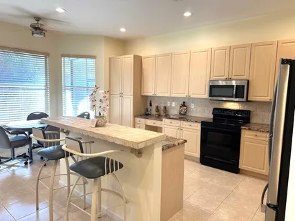 a kitchen with a stove a sink and a refrigerator