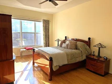 a spacious bedroom with a bed and window