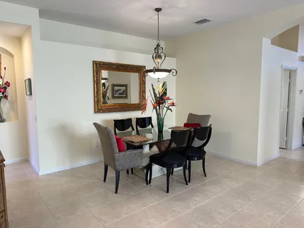 a dining room with furniture a chandelier and a rug