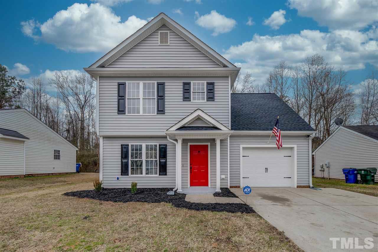 5408 Gunnette Drive Raleigh, NC 27610 - Photo 1 of 23 a front view of a house with a yard and garage