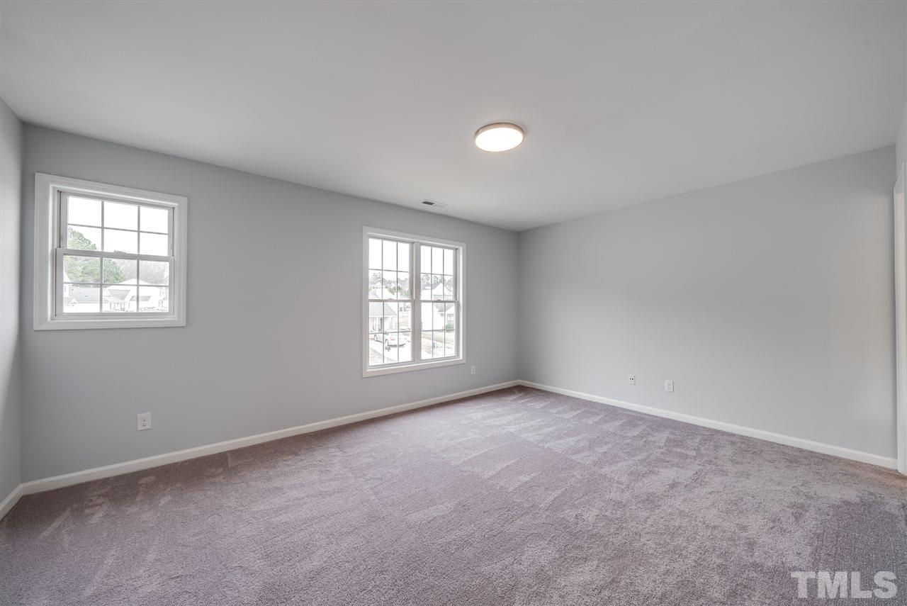 5408 Gunnette Drive Raleigh, NC 27610 - Photo 18 of 23 an empty room with windows