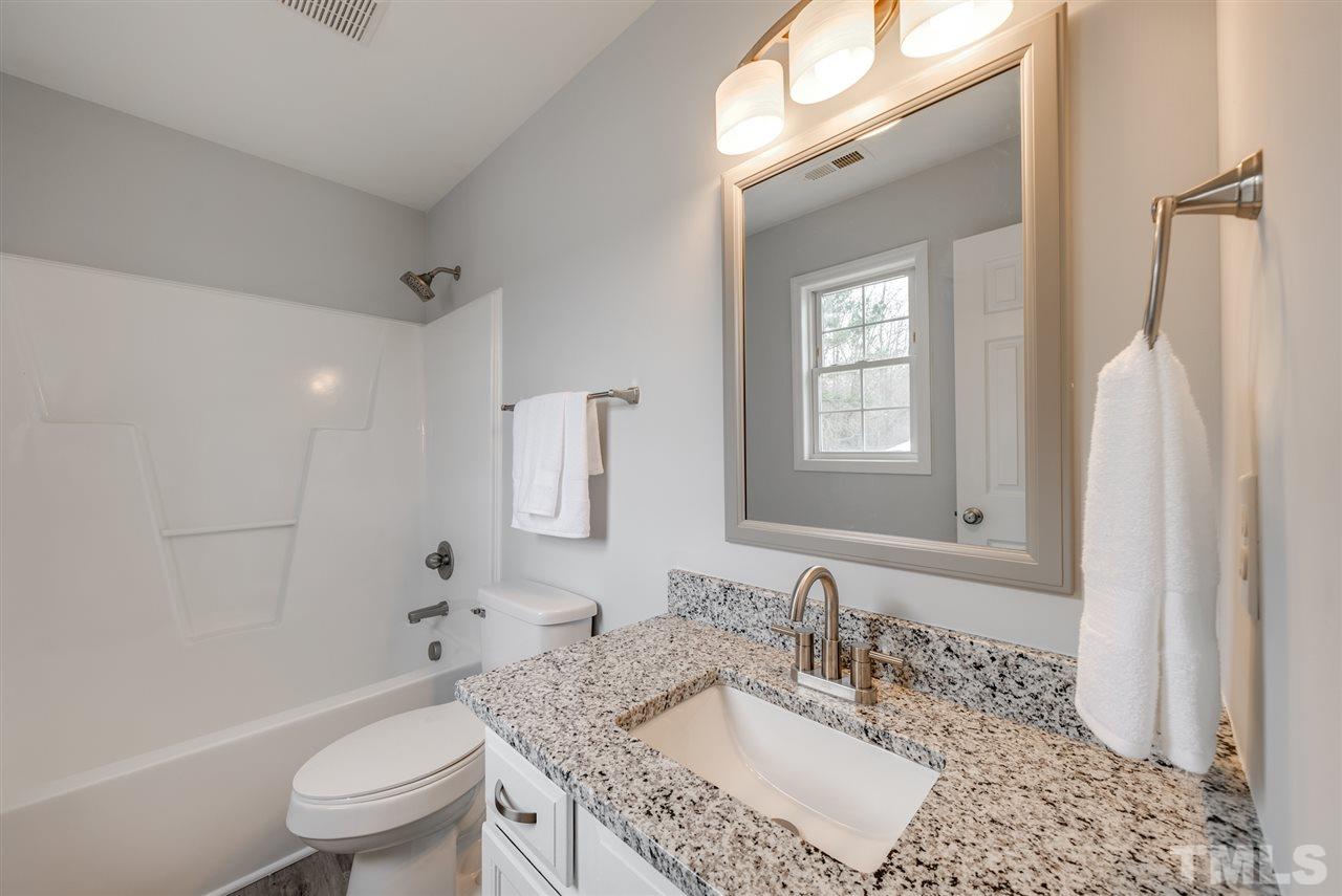 5408 Gunnette Drive Raleigh, NC 27610 - Photo 20 of 23 a bathroom with a granite countertop sink toilet and shower