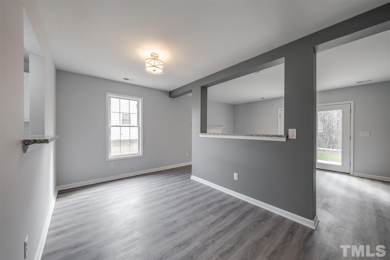 5408 Gunnette Drive Raleigh, NC 27610 - Photo 6 of 23 an empty room with wooden floor and windows