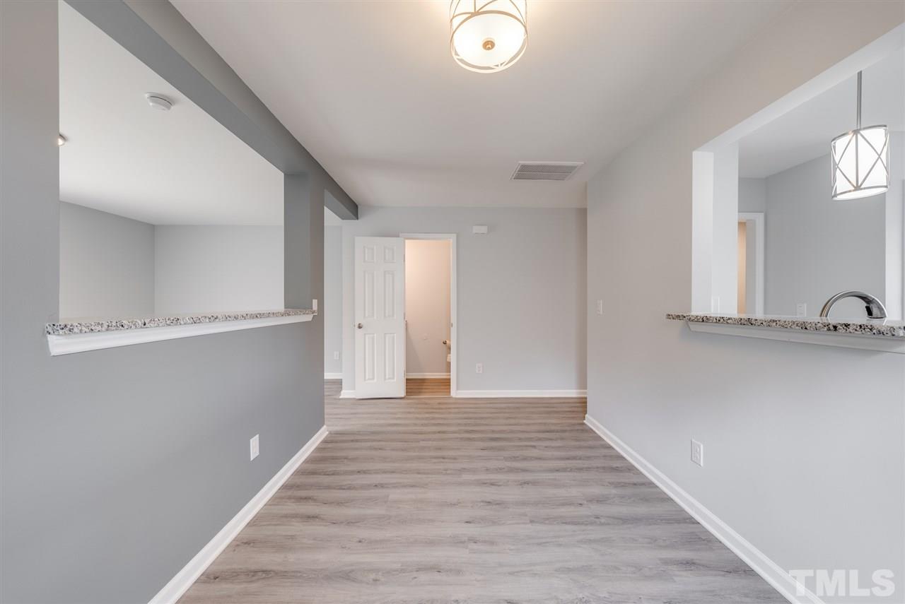 5408 Gunnette Drive Raleigh, NC 27610 - Photo 8 of 23 a view of a hallway with wooden floor