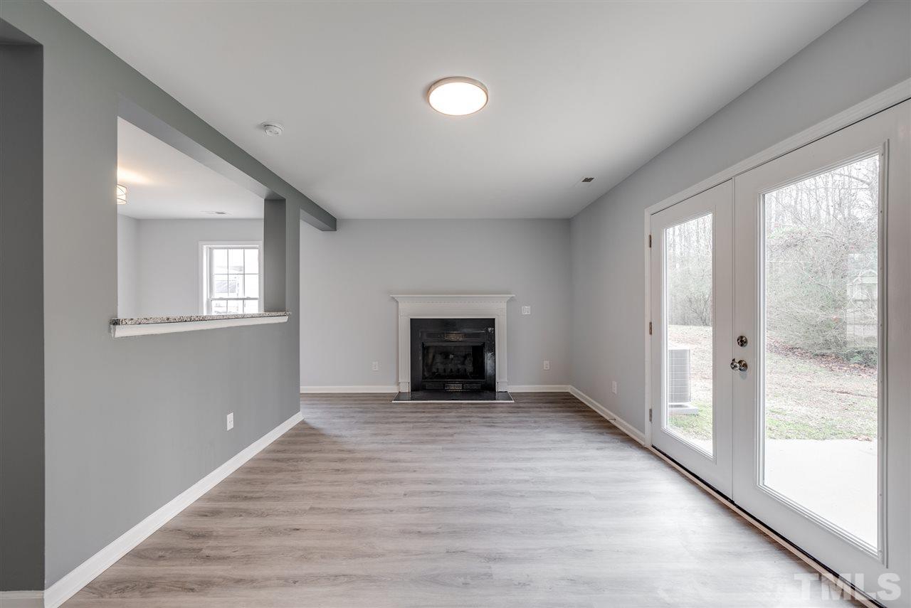 5408 Gunnette Drive Raleigh, NC 27610 - Photo 9 of 23 a view of an empty room with a window and fireplace