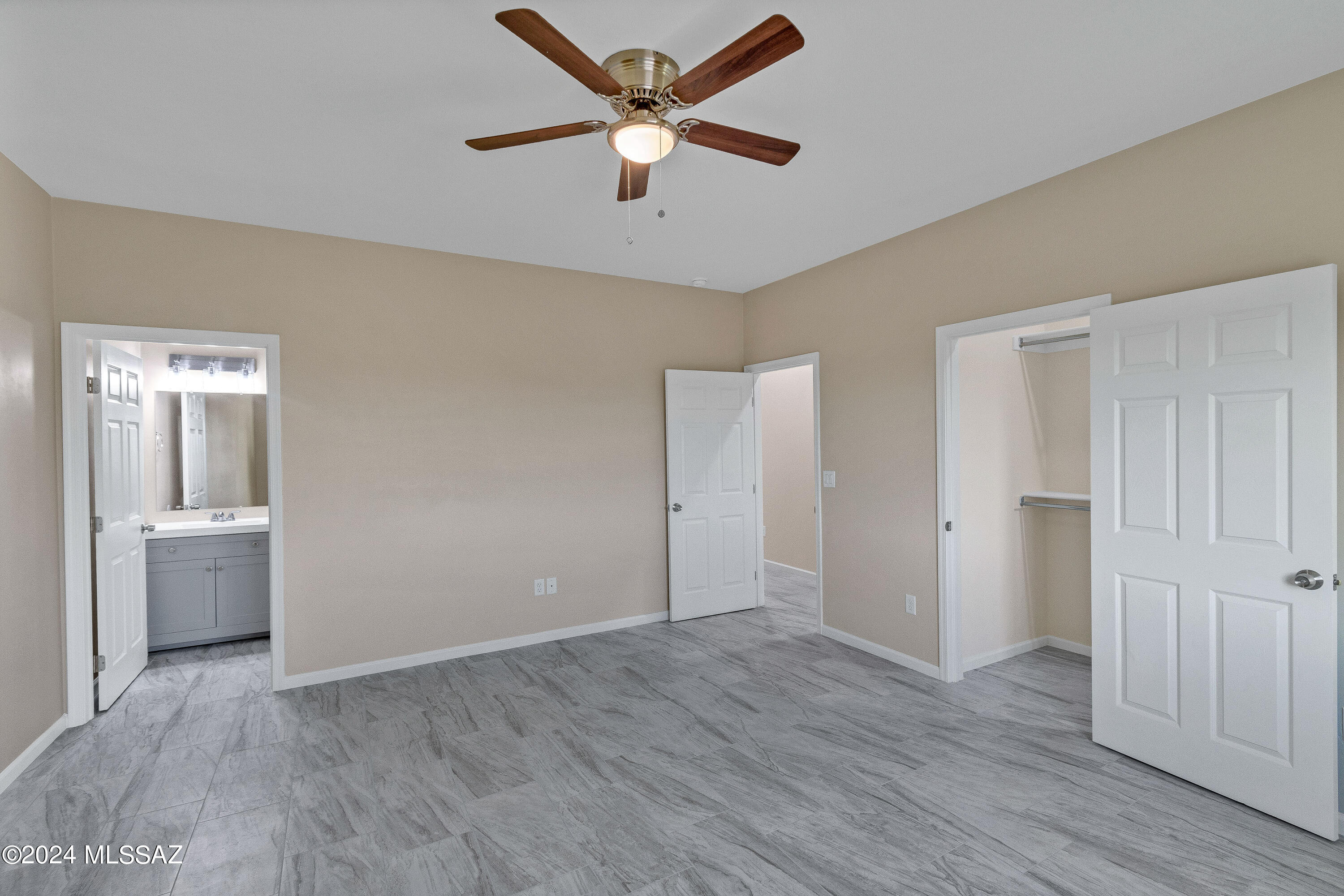 356 Globo Court Rio Rico, AZ 85648 - Photo 18 of 32 a view of an empty room and window and wooden floor