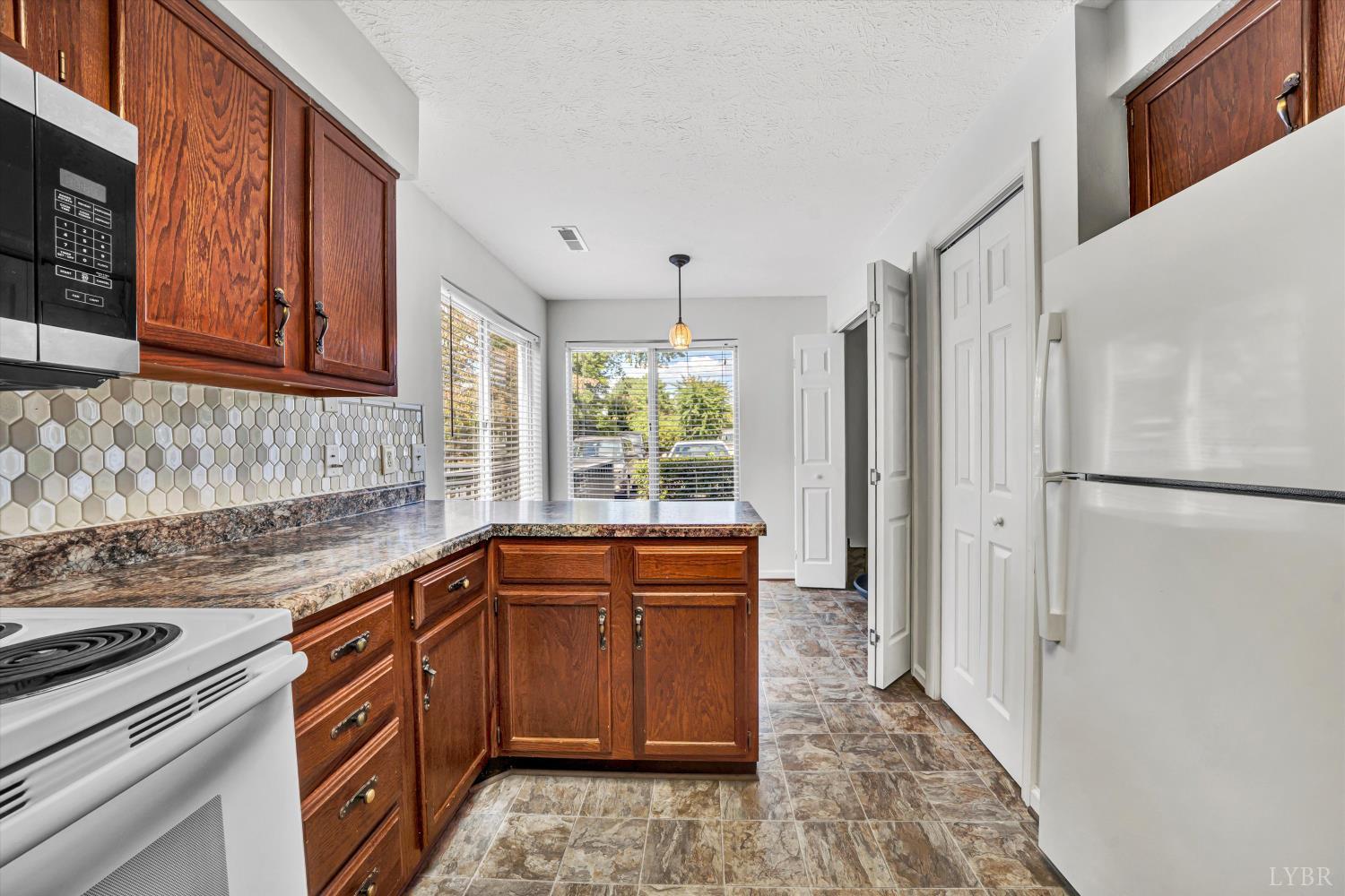 3114 Spinnaker Point Forest, VA 24551 - Photo 16 of 47 a kitchen with stainless steel appliances granite countertop a refrigerator and a sink