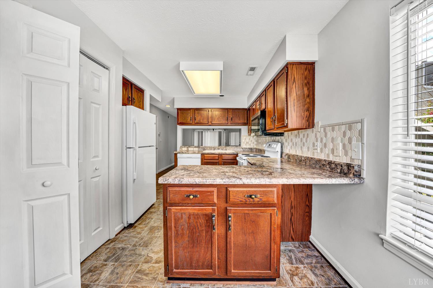 3114 Spinnaker Point Forest, VA 24551 - Photo 19 of 47 a kitchen with kitchen island granite countertop wooden cabinets and a sink