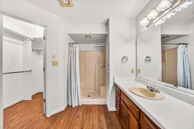 a bathroom with a sink a mirror and a shower
