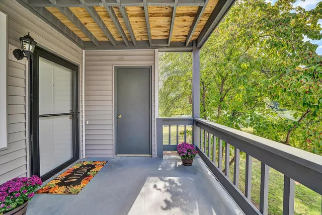 a view of two chairs in the balcony