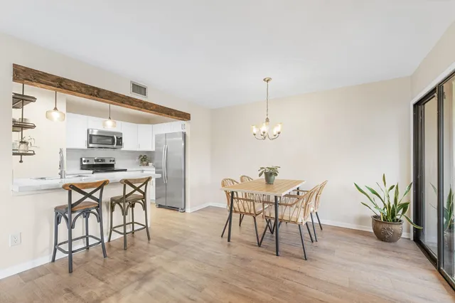 a view of a dining room with furniture and window