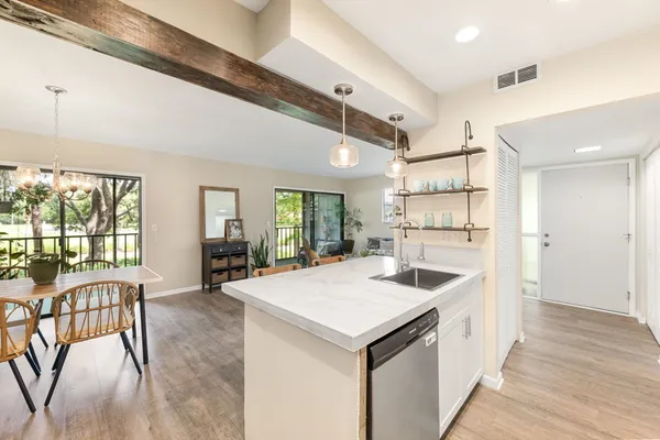 a view of a kitchen with a sink and a large window