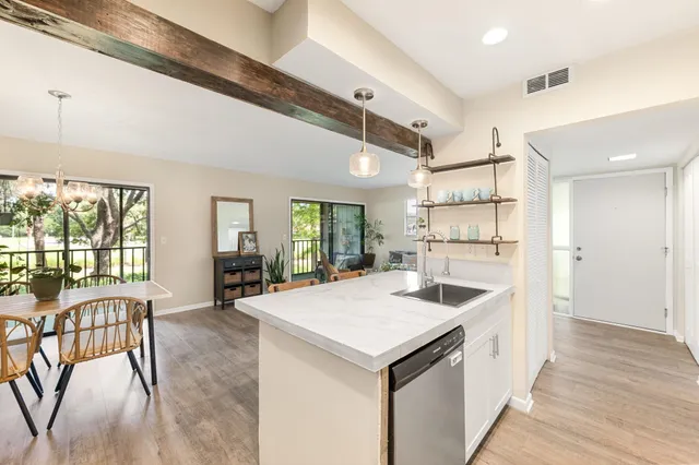 a view of a kitchen with a sink and a large window