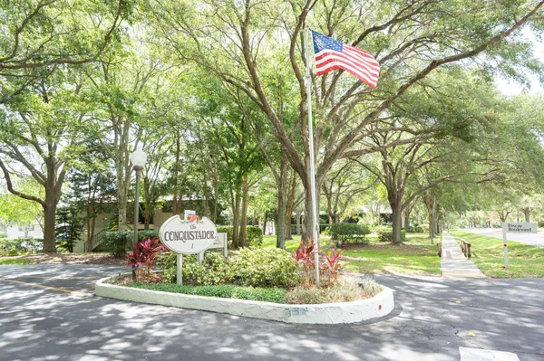a park view with a fountain and trees