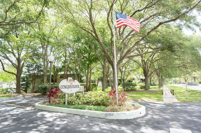 a park view with a fountain and trees