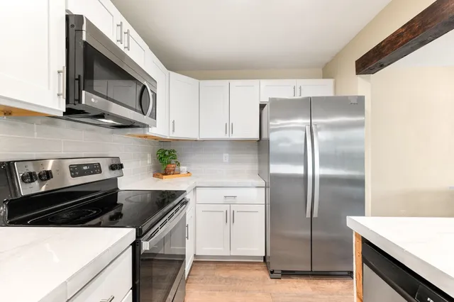 a kitchen with a stove a microwave and a refrigerator