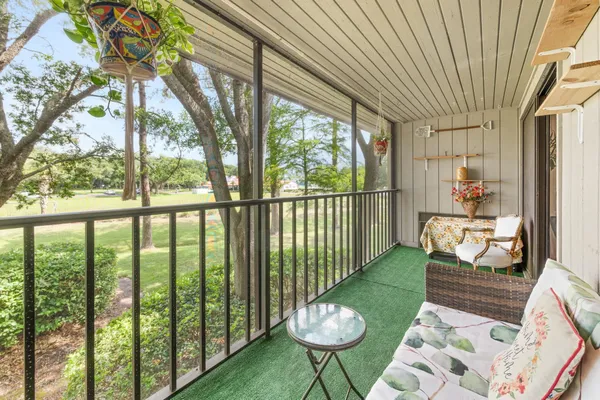 a view of a chair and tables in the balcony