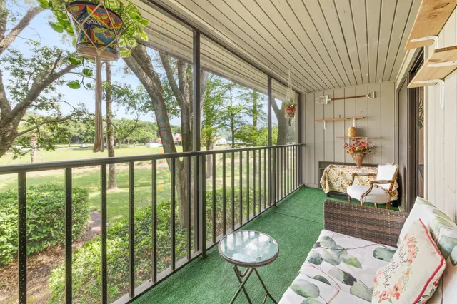 a view of a chair and tables in the balcony