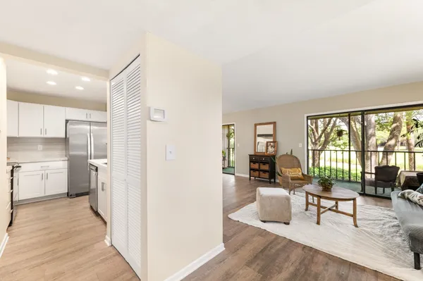 a living room with furniture and a floor to ceiling window