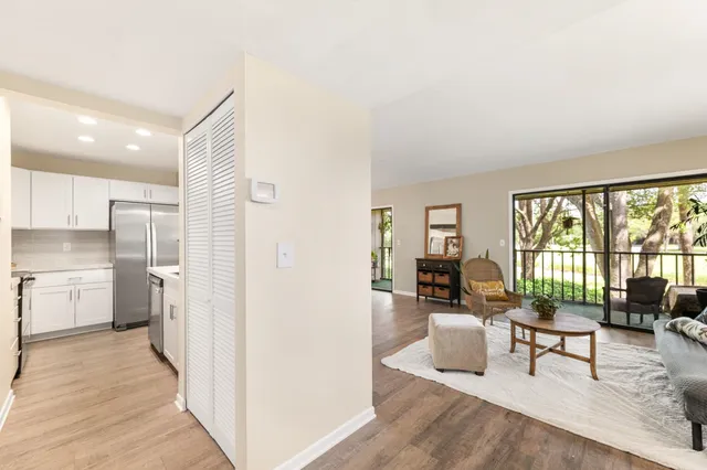 a living room with furniture and a floor to ceiling window
