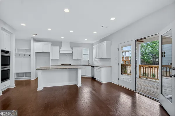 a kitchen with white cabinets and a sink