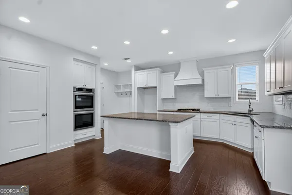 an empty room with a window and a ceiling fan