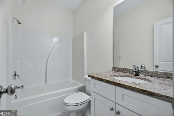 an empty room with fan and windows